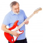 Old guy playing a red guitar